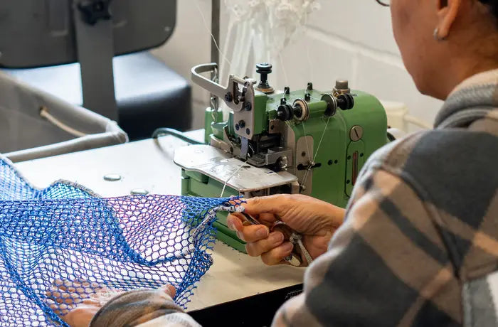 Sling mesh and cord being stitched on the shop floor