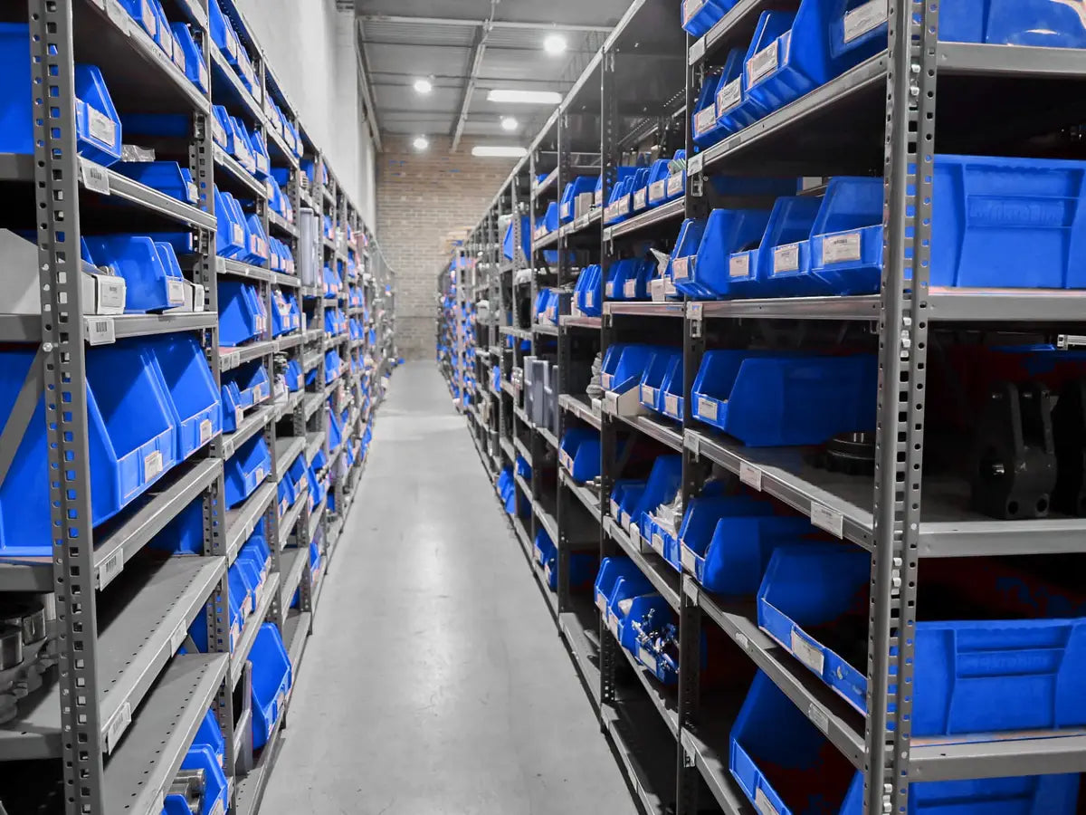 Aisle of stocked parts bins in the Tingue warehouse
